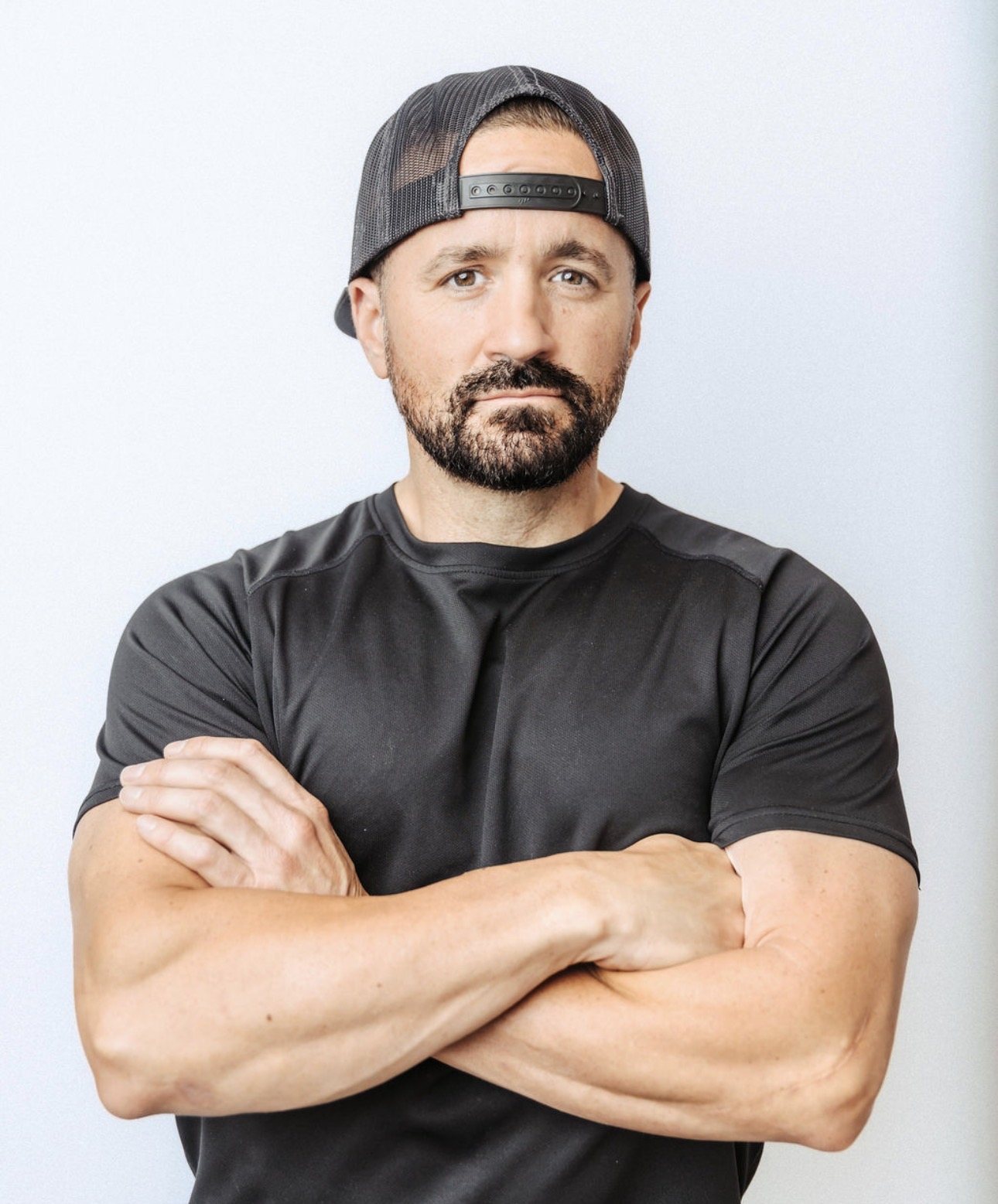 Studio portrait of Shawn Taylor with arms crossed, looking straight at the camera